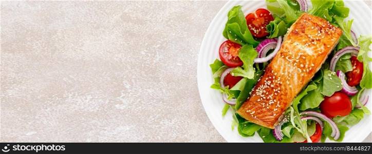 Grilled salmon fish fillet and fresh vegetable salad with tomato, red onion and lettuce. Banner