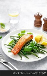 Grilled salmon fish fillet and green beans with lemon and basil