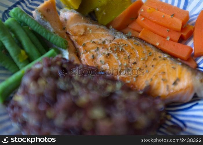 Grilled salmon fish, rice and vegetable in dish