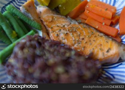 Grilled salmon fish, rice and vegetable in dish