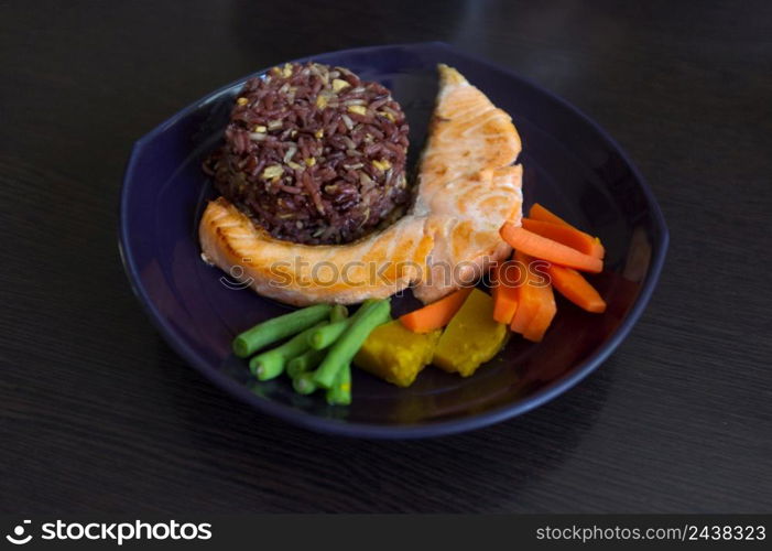 Grilled salmon fish, rice and vegetable in dish