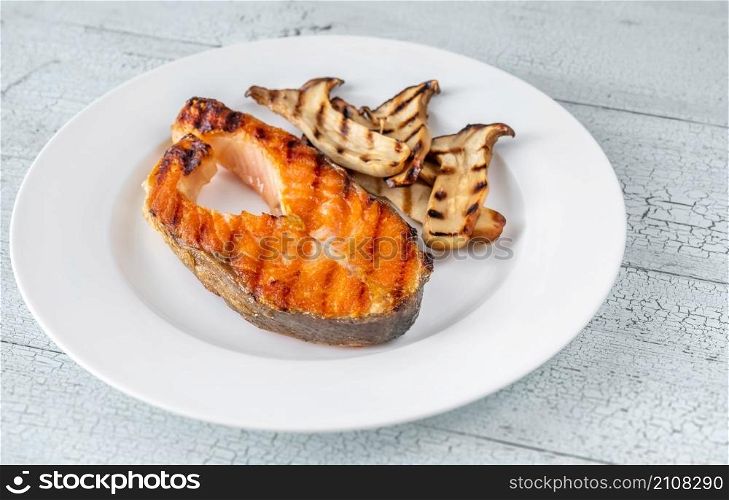 Grilled salmon steak garnished with fried eryngii mushrooms