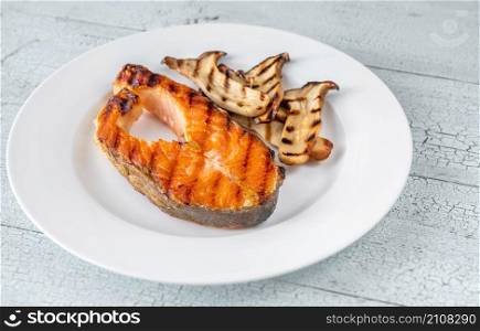 Grilled salmon steak garnished with fried eryngii mushrooms