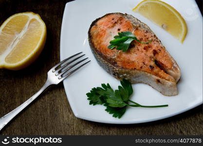 grilled salmon steak on a square white plate