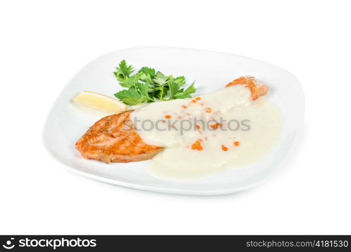 Grilled salmon steak with cheese sauce, greens, lemon and red caviar