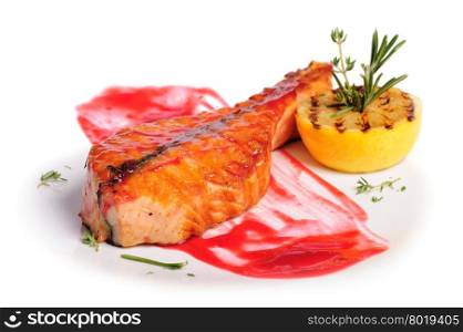 Grilled salmon steak with red sauce, lemon and rosemary, on white