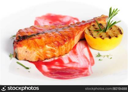 Grilled salmon steak with red sauce, lemon and rosemary, on white