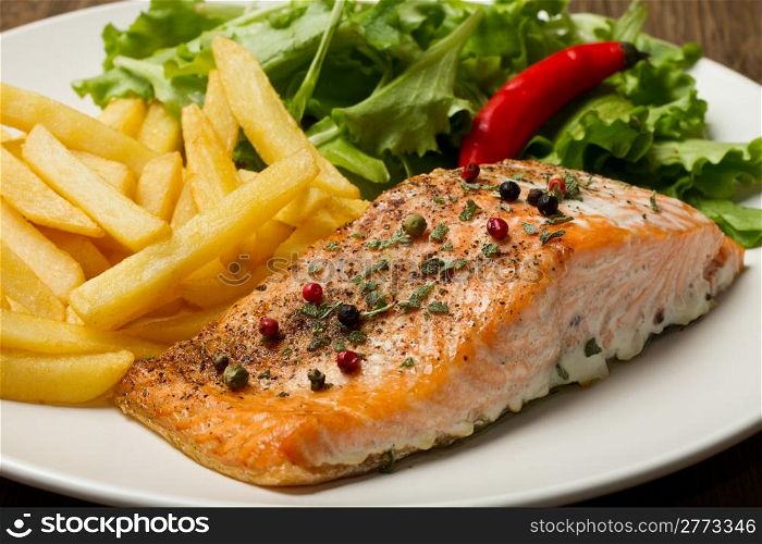 grilled salmon with chips and fresh salad