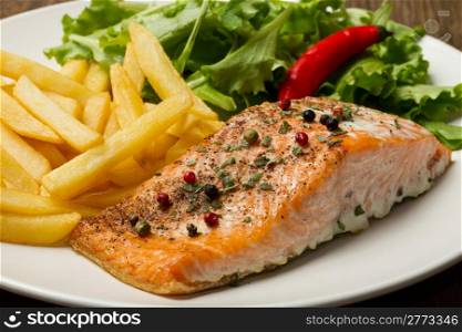 grilled salmon with chips and fresh salad