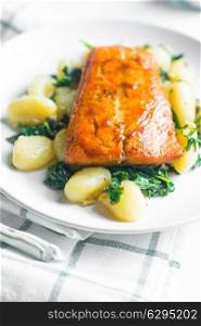Grilled salmon with gnocchi and greens