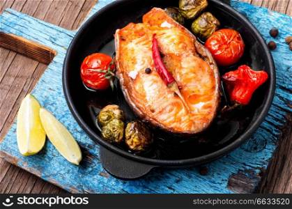 Grilled salmon with vegetables.Fish steak with vegetable garnish.Fish food. Baked salmon steak