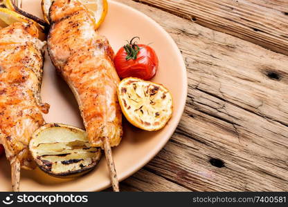 Grilled salmon with vegetables on wooden table.Healthy food. Grilled salmon on skewer