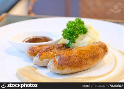 grilled sausage and mashed potato served with sweet sauce