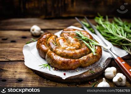 Grilled sausage on dark rustic wooden background