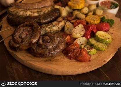 Grilled sausage with vegetables. Grilled sausage with vegetables surved with sauce