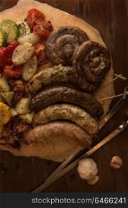 Grilled sausage with vegetables. Grilled sausage with vegetables surved with sauce