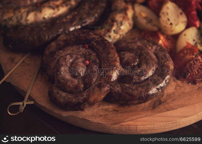 Grilled sausage with vegetables surved with sauce. Grilled sausage with vegetables