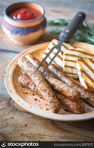 Grilled sausages and cheese with rosemary