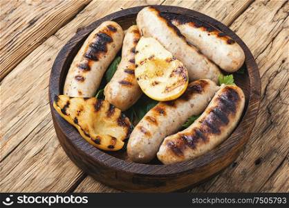 Grilled sausages and vegetables on wooden table.Bbq food. Grilled sausages with vegetables