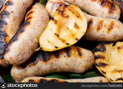 Grilled sausages fried with pear and.Autumn food.Grill menu. Tasty grilled sausages