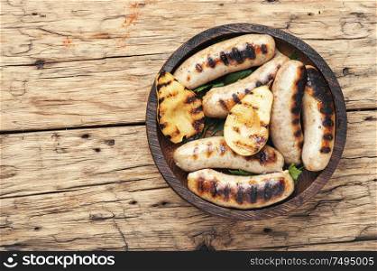Grilled sausages fried with pear and.Grill menu.Bbq food. Grilled sausages with pear