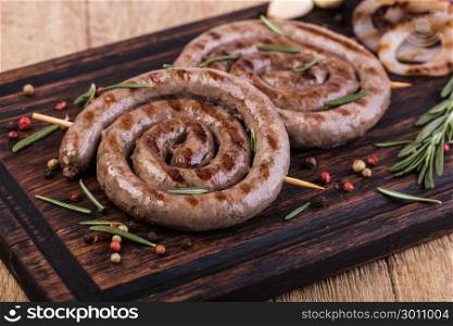 Grilled sausages. Grilled sausages on a wooden cutting board