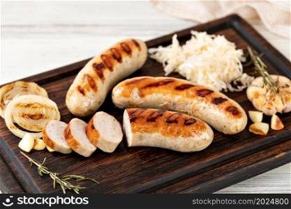 Grilled sausages on a wooden cutting board. Grilled sausages