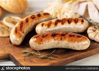 Grilled sausages on a wooden cutting board. Grilled sausages