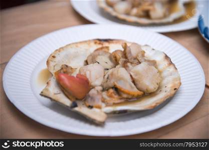 Grilled scallops topped with butter