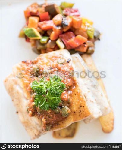 Grilled seabass fish with grilled vegetable on fries. Grilled seabass