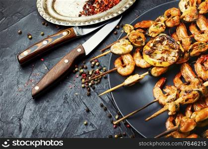 Grilled shrimp and mussels on wooden stick. Grilled shrimps and mussels