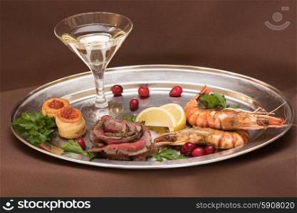 Grilled shrimps and beef meat . Grilled shrimps and beef meat on a plate