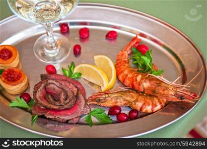 Grilled shrimps and beef meat . Grilled shrimps and beef meat on a plate