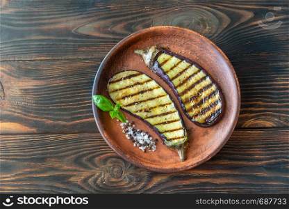 Grilled slices of aubergine with seasonings on the plate