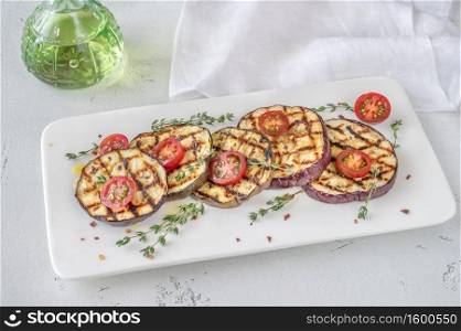 Grilled slices of eggplant with olive oil and fresh thyme
