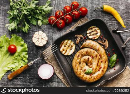 grilled snail sausages pan with spices vegetable wooden grey backdrop