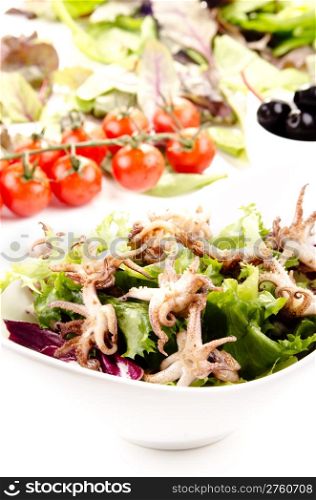 grilled squid with fresh salad in a white bowl