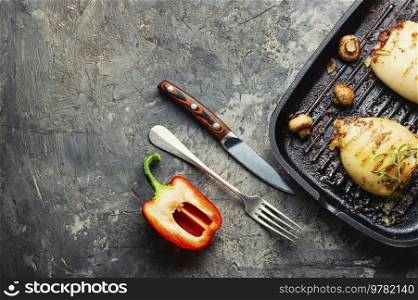 Grilled squids with vegetable stuffing. Stuffed calamari in grill pan. Grilled squid stuffed with vegetables, space for text