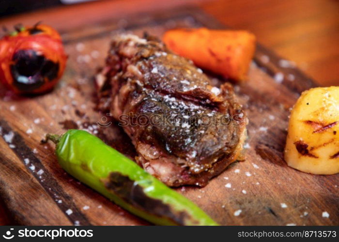 Grilled steak on a wooden plate