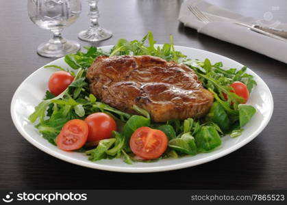 Grilled steak with bacon salad of arugula