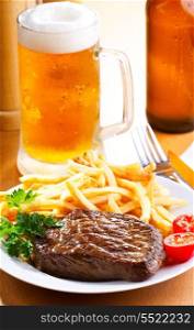 grilled steak with french fries and beer