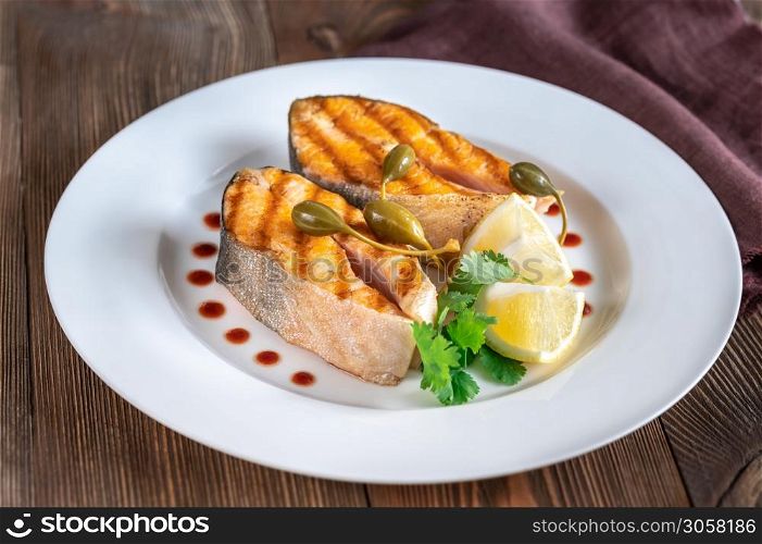 Grilled steaks of Arctic char on the white plate