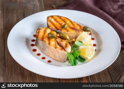 Grilled steaks of Arctic char on the white plate