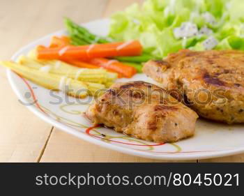 Grilled steaks on white dish with salad