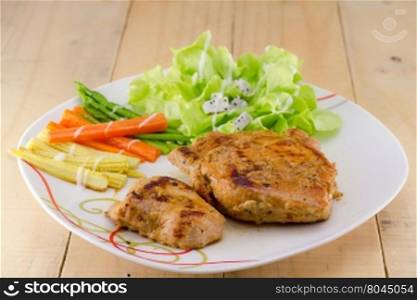 Grilled steaks on white dish with salad