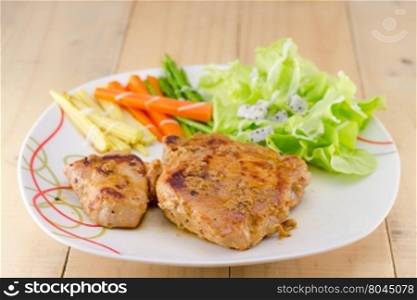 Grilled steaks on white dish with salad