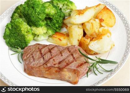 Grilled striploin steak (new york steak) served with crushed garlic potatoes and boiled broccoli