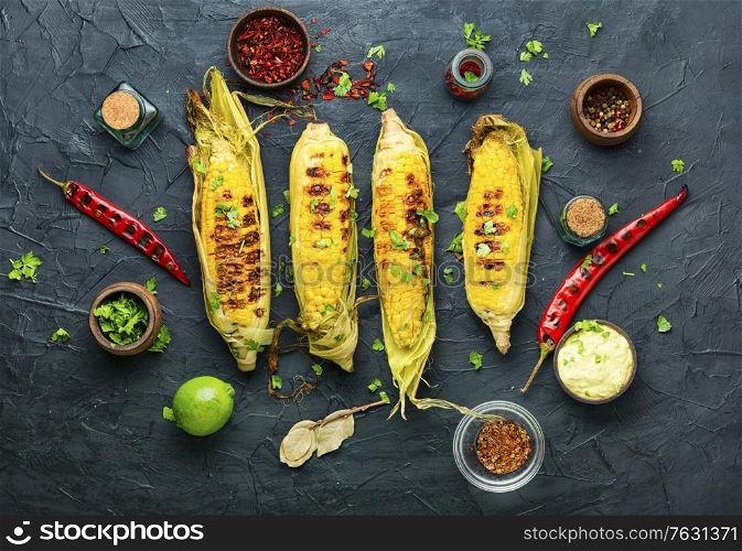 Grilled sweet corn with sauce and spicy.Summer vegan snack. Grilled corn cobs