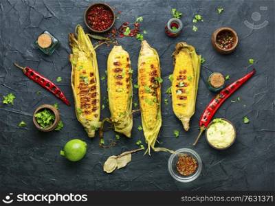 Grilled sweet corn with sauce and spicy.Summer vegan snack. Grilled corn cobs