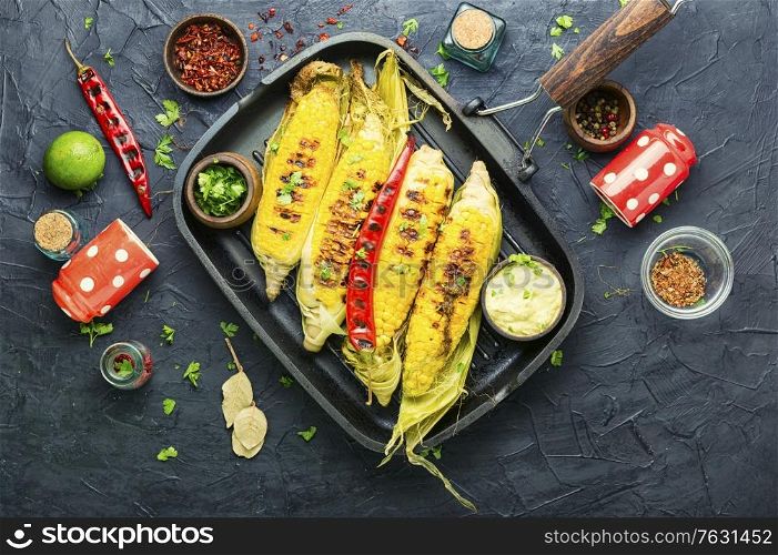 Grilled sweet corn with sauce and spicy.Summer vegan snack. Grilled sweet corn cob